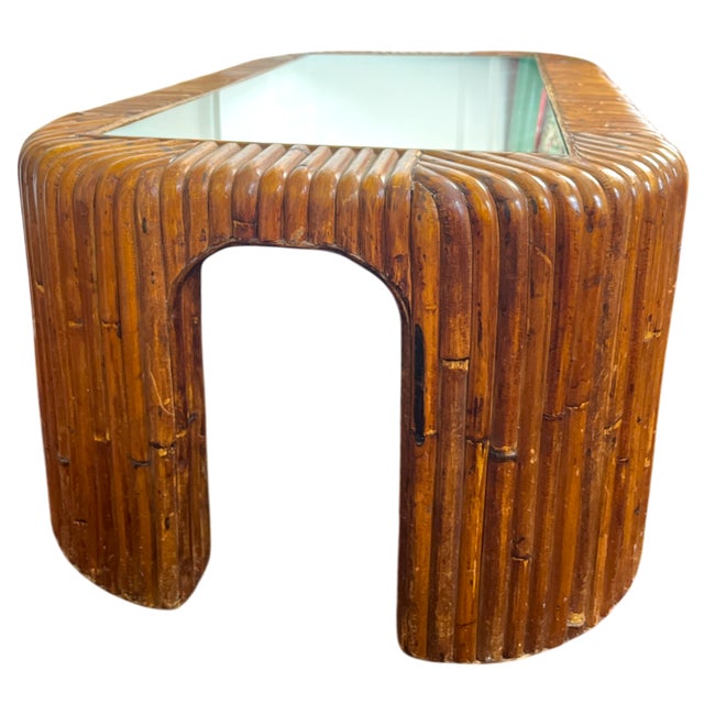 Striking and architectural 1970s coffee table featuring a sculptural, bent split reed wooden frame with softly rounded...
