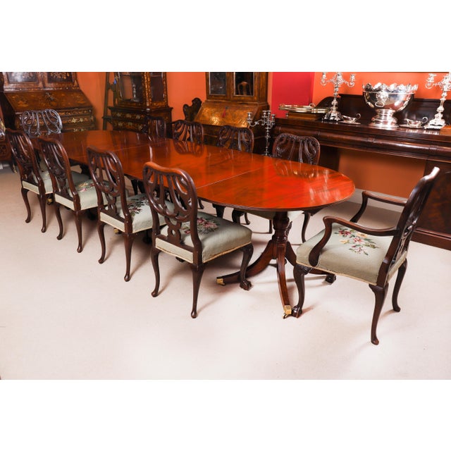This is an elegant antique George IV Regency triple pillar flame mahogany dining table that dates from Circa 1820. The...