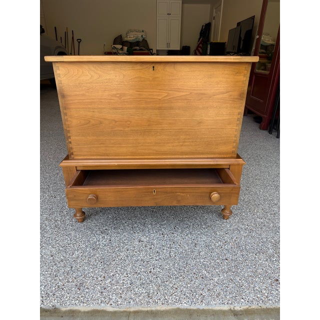 Solid cherry mule chest featuring a single lower drawer and turned arrow point legs. Hinged top allows for storing...