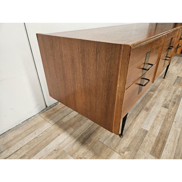 An elegant 1960s Italian chest of drawers, crafted from walnut with a refined design featuring clean lines and sleek...
