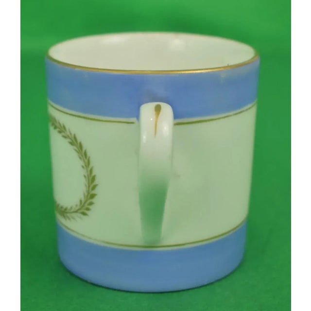 This is an antique pair of mugs from the early 20th century. The pieces feature the numbers 5 and 6, respectively. Sz:...