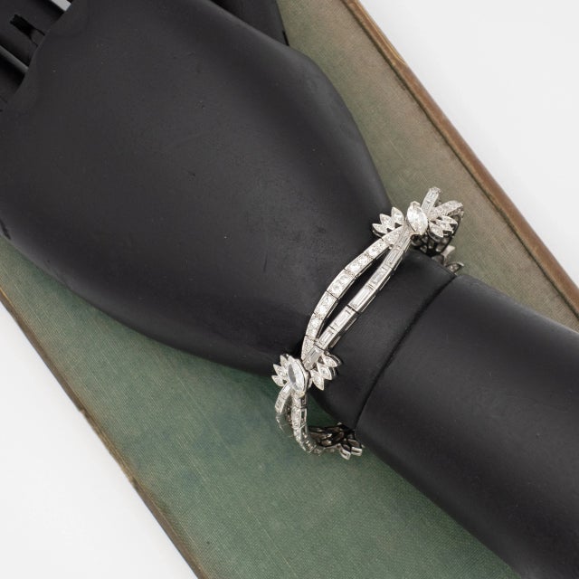 Vintage ER platinum diamond bracelet. Floral crisscross design encrusted with high quality diamonds in round brilliant,...