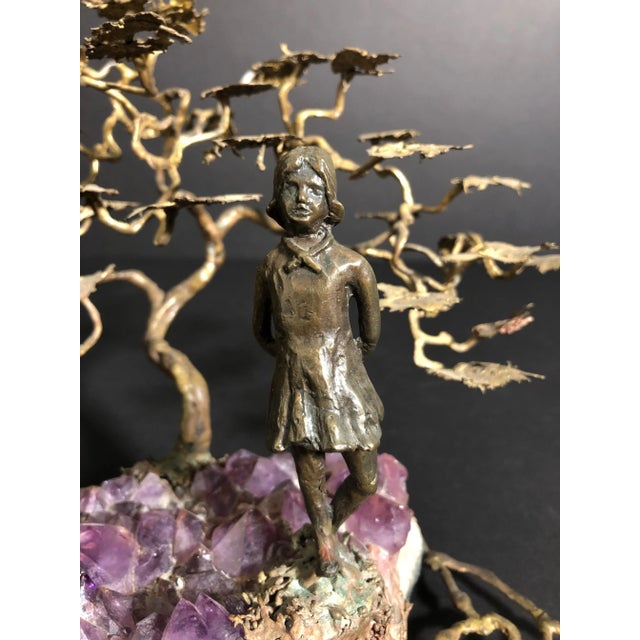 Ron Bertocchi bronze sculpture of a young girl standing, mounted on a natural amethyst stone ground at the edge of pond...