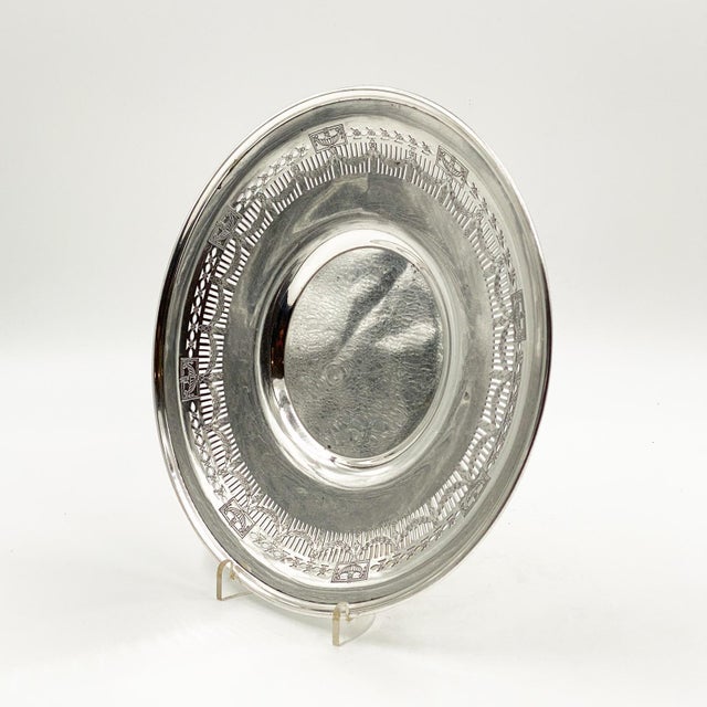 A vintage Middletown silver plate serving plate with a Neoclassical design and pierced border.