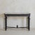 An Italian console table of striking composition, dating back to the 18th-century. Crafted from ebonized wood, its...
