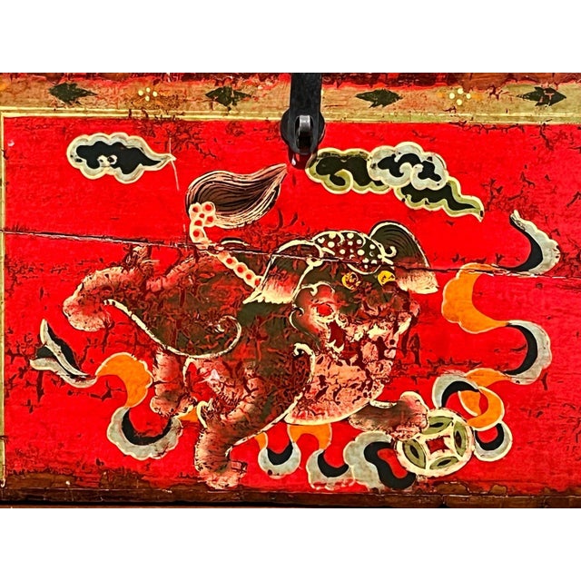 An authentic 19th to early 20th century Tibetan / Asian hand-painted red lacquer wooden storage trunk, measuring...