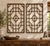 Two tall lattice panels, each a grid of slender wooden bars with a cloud-shaped medallion at the center and curled ruyi...
