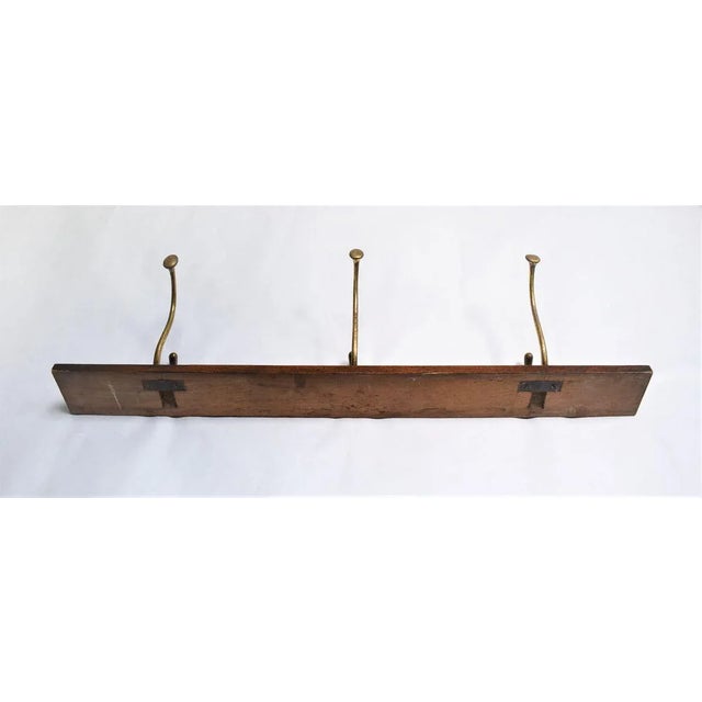 Antique coat rack with 3 coat hooks made of brass. The hooks were designed by Adolf Loos for the Cafe Capua in Vienna....
