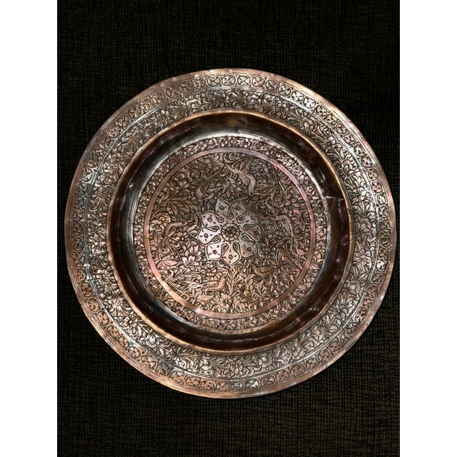 This plate is a splendid example of the ancient art of Ghalamzani. It has a hand engraved intricate floral and bird motif....