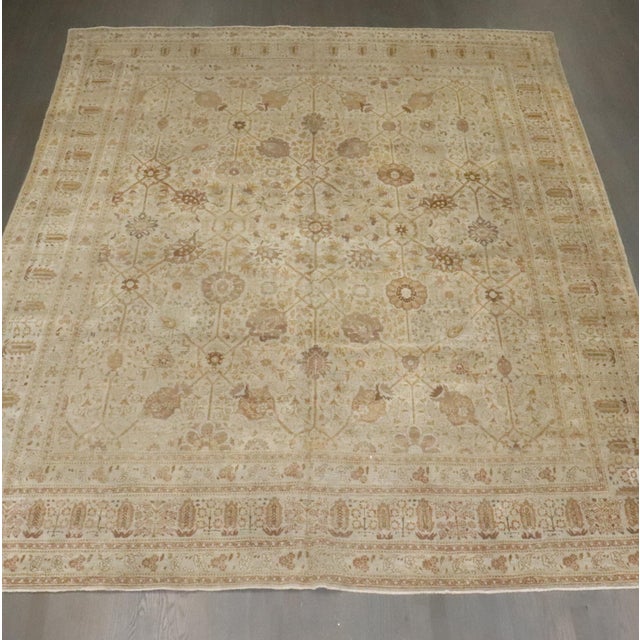 An early 20th-century Persian Tabriz with an all-over design. Beige, brown, umber accents. Measures: 9'2" x 12'3".