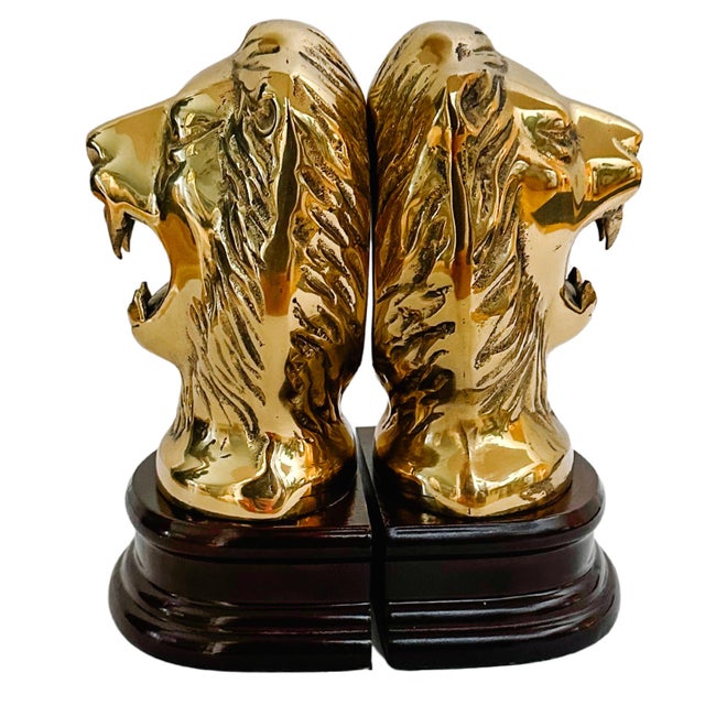 Pair of 1970s solid brass roaring lions on mahogany bases. These are substantial in size and weight and are highly visible...