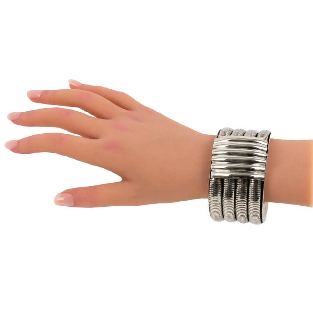 This stunning modernist bracelet bangle features a chunky, massive shape in chromed metal, all carved and textured with a...