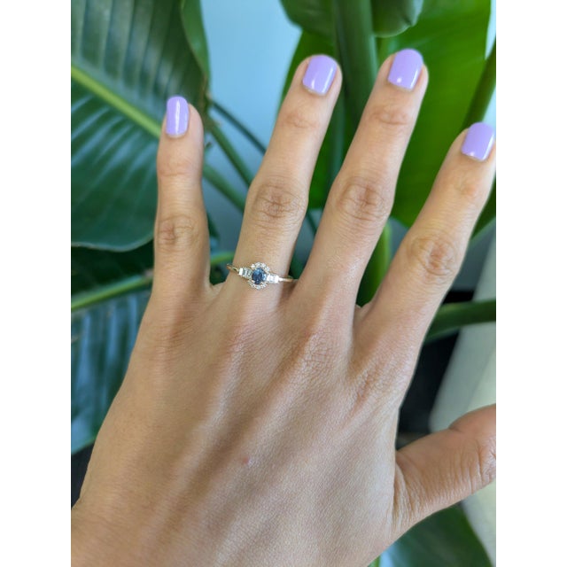 A natural color-change alexandrite glows at the centre of this solid 14K yellow gold ring, framed by fourteen earth-mined...