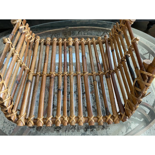 Super stylish French vintage bamboo magazine holder with handle. This piece has a wonderful patina, clean lines, and is in...