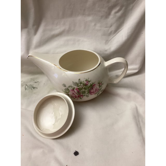This incredible teapot has two clusters of delicate pink roses with green foliage on each side, and a matching floral...