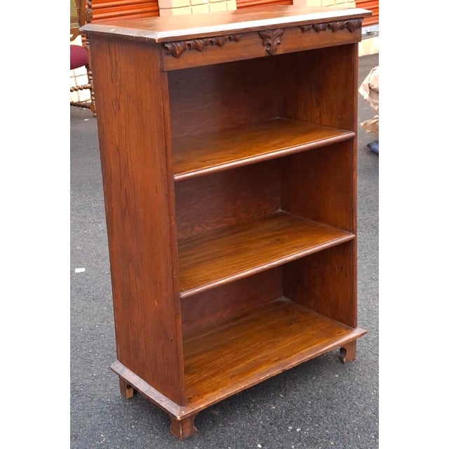 A Victorian Renaissance Revival Carved Oak Bookcase, Circa 1900s Measuring 25.25" in width, 12.5" in depth and 38"....