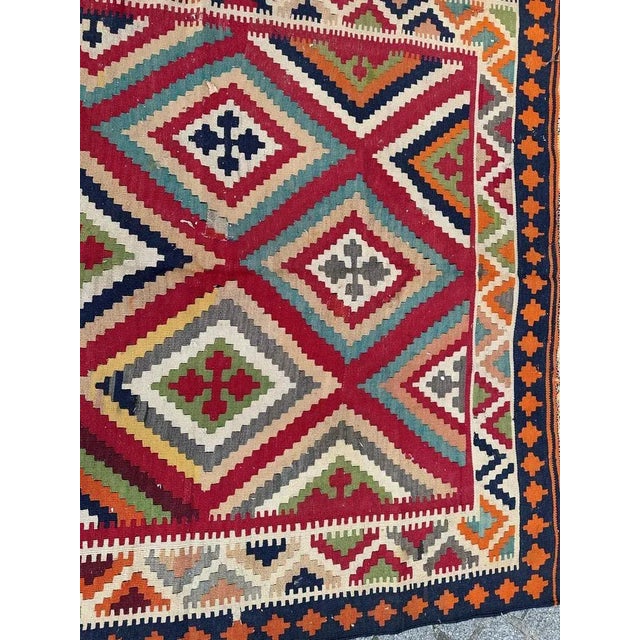 Exquisite Qashqai antique Kilim, meticulously handwoven with wool on a cotton foundation. Featuring a captivating...