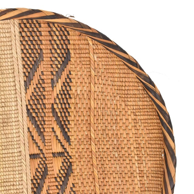 Gokwe baskets, handwoven by the people of rural Zimbabwe's Gokwe region, showcase intricate designs and vibrant hues using...