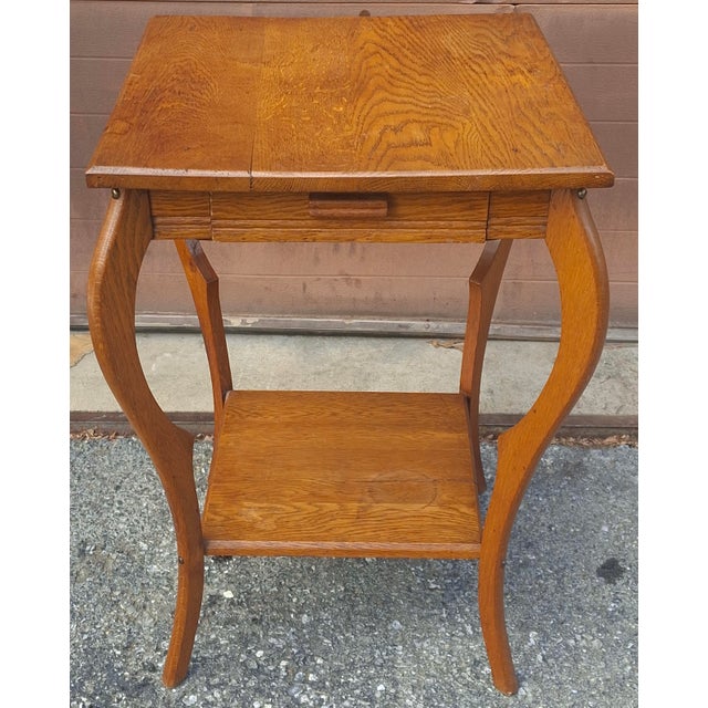A late 19th Century Victorian aarts and Crafts Style Oak Two-Tier Single Drawer Side Table. Measures 21" in width, 21" in...