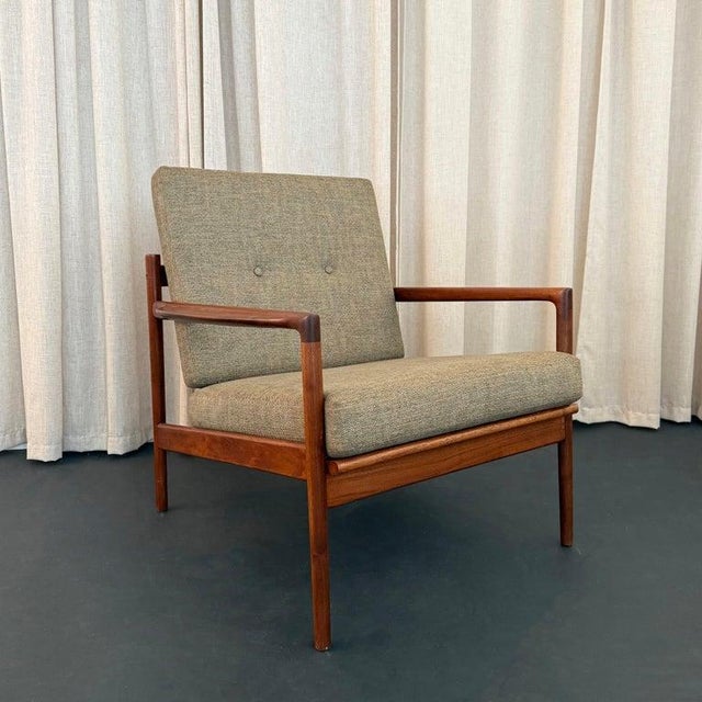 This stylish Scandinavian Modern teak lounge chair was designed by Danish designer Ib Kofod-Larsen for the furniture...