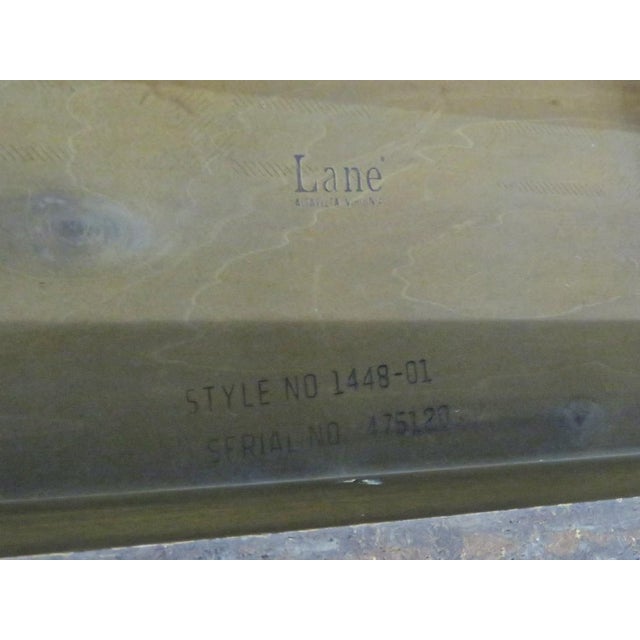 Vintage modern coffee table featuring an inlayed top and rich oak wood grain throughout. Please confirm item location with...