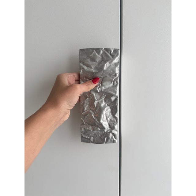 Architectural jewelry for cabinetry and doors. A new, never installed pair of “Crushed” sculptural pulls by renowned...