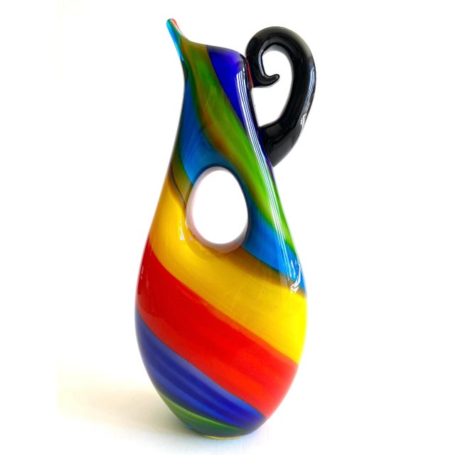 This rare vintage 1980's Postmodern Italian Murano art glass fused multicolor stripe sculptural pitcher vase is an...