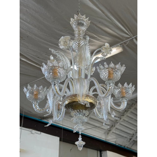 1980s Murano glass chandelier with 6 lights. Featuring classic floral details, straight leaves, and hand-crafted curved...
