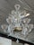 1980s Murano glass chandelier with 6 lights. Featuring classic floral details, straight leaves, and hand-crafted curved...