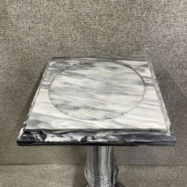 Beautiful Solid Vintage Marble Pedestal. Crafted from solid marble, this pedestal blends both white and black marble,...