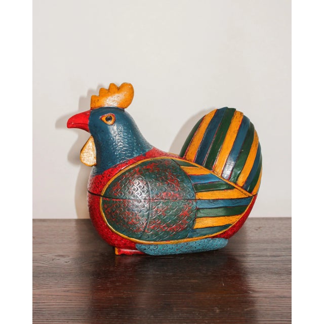 Bright and handsomely painted wooden rooster handmade in Northern Thailand. Separates horizontally into two pieces to...