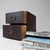 A small Japanese wooden drawer cabinet from the early Taishō period, with two drawers, metal ring handles and hand-painted...
