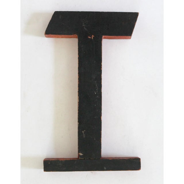 Circa 1940 Art Deco-style handmade wood orange and black letter T. Letter has scratches, chips, discolorations.