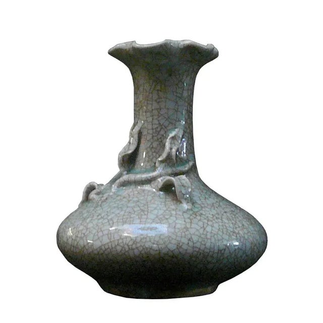 This is a hand made pottery vase in crackle pattern celadon light green color with relief flower accent. Dimensions: Dia...