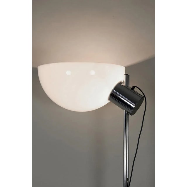 The large floor lamp was produced by Guzzini in the 1970s. It features a large acrylic glass reflector. European Plug (up...