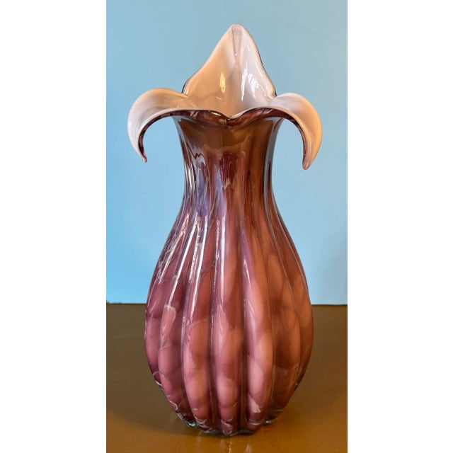 This 12-inch tall Murano Art Glass vase is a masterpiece of glass of blowing. Its bulbous body features a delicate fluted...