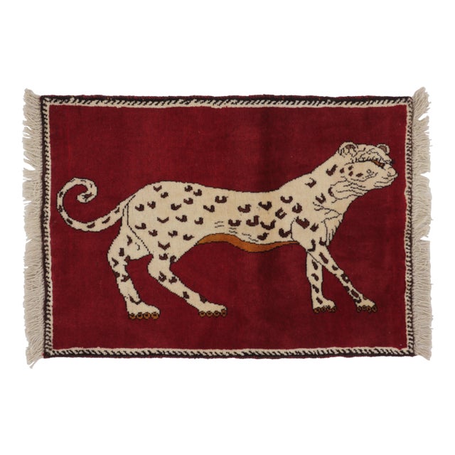 Hand-knotted in wool and originating circa 1950-1959, this 2x3 vintage Gabbeh pictorial gift-sized rug is from Afghanistan...