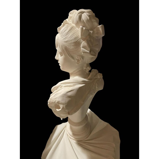 An elegant French mid-19th century plaster bust of a young lady, signed Albert-Ernest Carrier Belleuse. The bust of a...