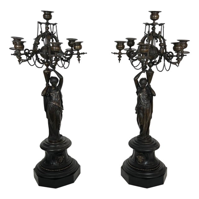 Pair of large patinated bronze candelabras representing caryatids For Sale