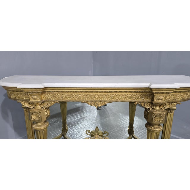 A superb quality early Victorian mirror backed breakfront console table, original carerra marble top and original gilding,...