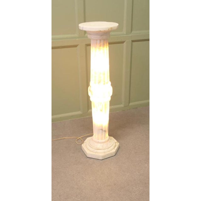 This large French white marble pedestal is hollow allowing it to be lit from the inside, the column has a stepped...