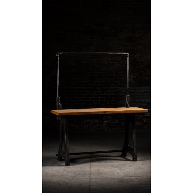 Industrial workbench assembled from a vintage laminated butcher-block top and substantial cast-iron FAMCO machine base....