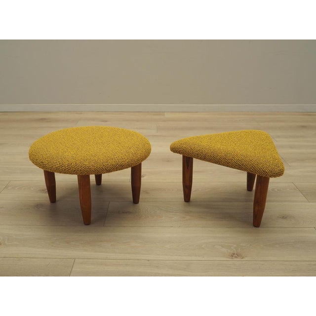 The set of two footstools was made in the 1990s in Denmark. The legs are made of solid beech wood. The wood has been...