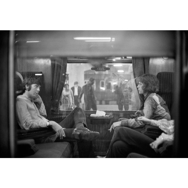 First Class Travel 25th August 1967: Paul McCartney of the Beatles and Mick Jagger of the Rolling Stones sit opposite each...