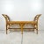 Vintage rattan bench. Long bench with Chinese chippendale fretwork detail. Cane wrapped joints. Curved arms on sides. A...