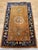 This beautiful vintage Chinese Art Deco area rug from the early 20th century showcases the warm elegance of a caramel-...