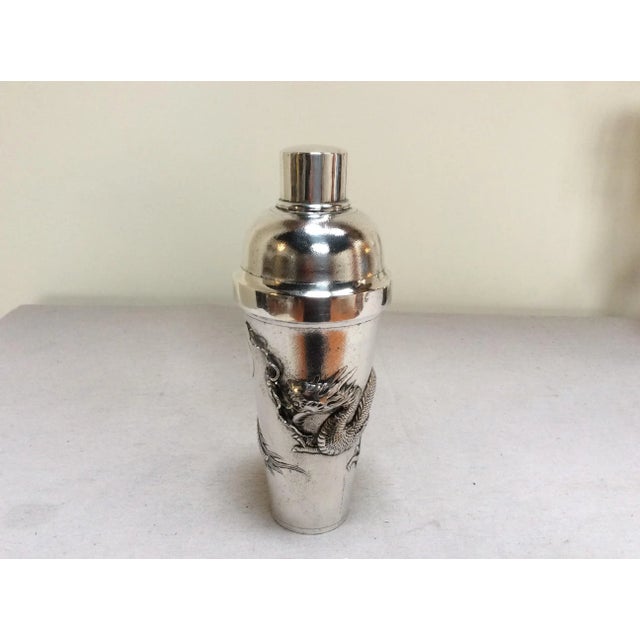 Offered is a Chinese sterling silver cocktail shaker with dragon design and hallmarks on the rim.