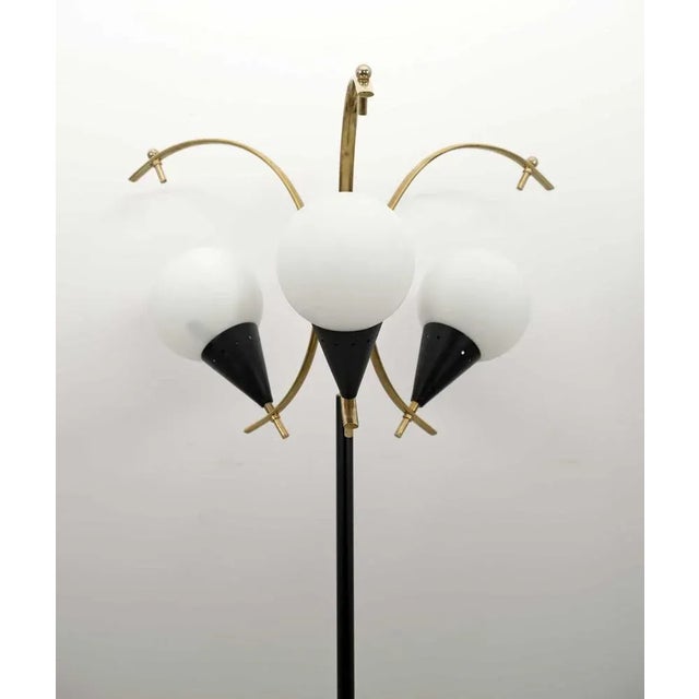 Glossy brass ground lamp, black lacquered metal, opal glass and marble base. Produced by Stilnovo in Italy in the 1950s....