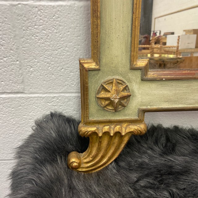 This Hollywood Regency Italian mirror is exceptional with its large central carved gilt shell in the crest and with...