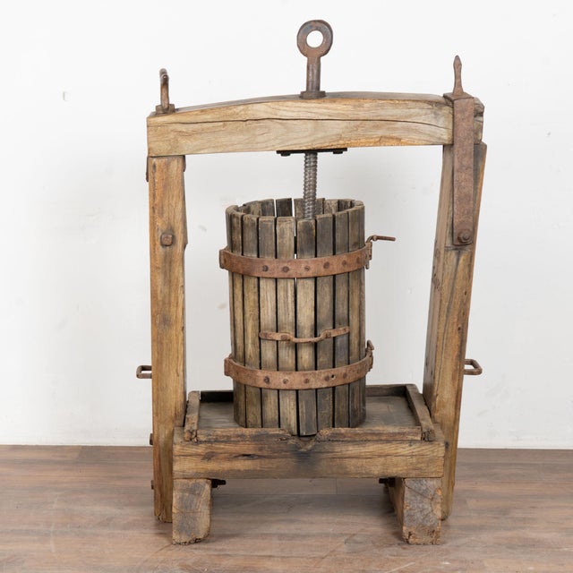 Antique wine press from Hungary. Note the heavy wrought iron bolts, bands and turning mechanism. Crafted in oak, the...